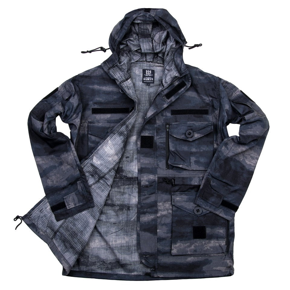 Chaqueta Smock 101 INC CQB Camo, capucha ajustable y protectores de codo extraíbles