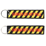 Llavero de nylon con los textos 'DANGER DO NOT PULL' y 'EMERGENCY USE ONLY'